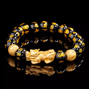 Pulseira da prosperidade Feng Shui com contas de obsidiana negra e charm dourado do Pixiu, simbolizando proteção, sorte e riqueza - Pelicano Azul