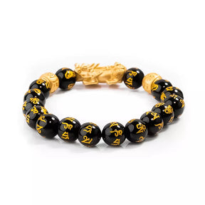 Pulseira da prosperidade Feng Shui com contas de obsidiana negra e charm Pixiu dourado, simbolizando proteção, sorte e riqueza - Pelicano Azul