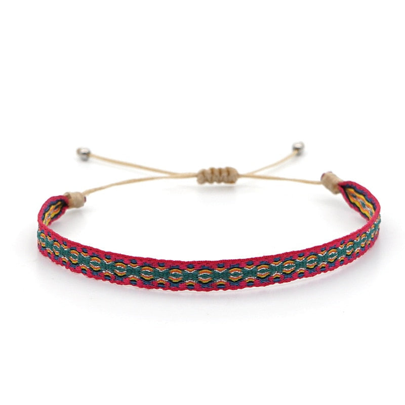 Pulseira ajustável com padrão colorido em verde e vermelho, parte do Conjunto Budista da Coragem, Pelicano Azul.