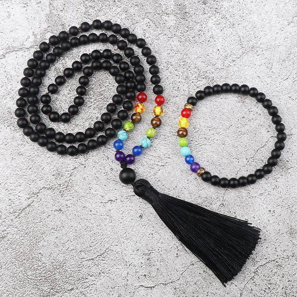 Japamala com 108 contas em Lava Vulcânica e pedras dos 7 Chakras, acompanhado de uma pulseira budista combinando e tassel preto elegante Pelicano Azul.