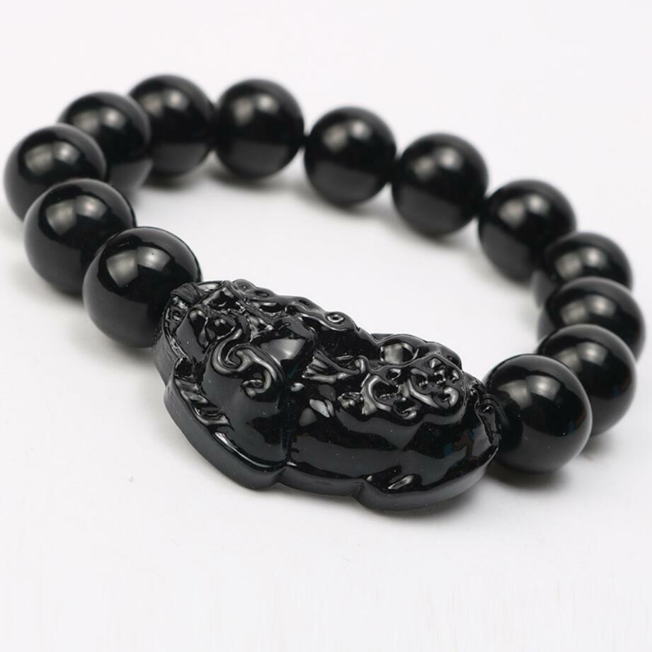 Pulseira Obsidiana Negra com entalhe detalhado de Feng Shui em fundo branco, Pelicano Azul.