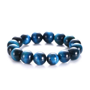 Pulseira com contas redondas de Olho de Tigre Azul, com brilho intenso, representando proteção e força espiritual, Pelicano Azul.